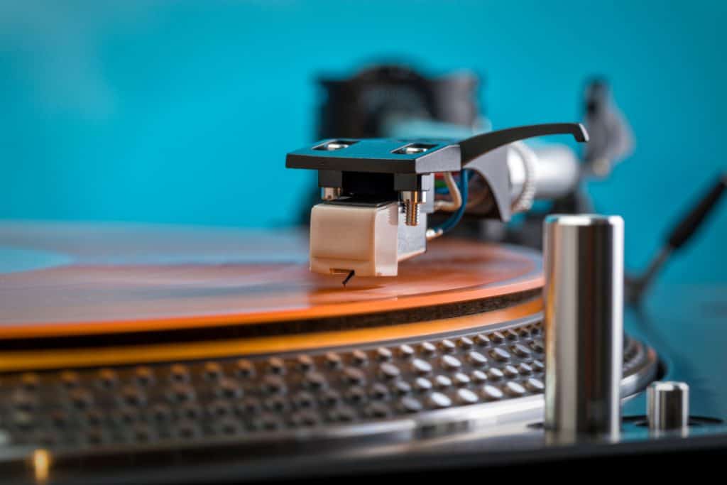 tonearm clear orange vinyl record turquoise background