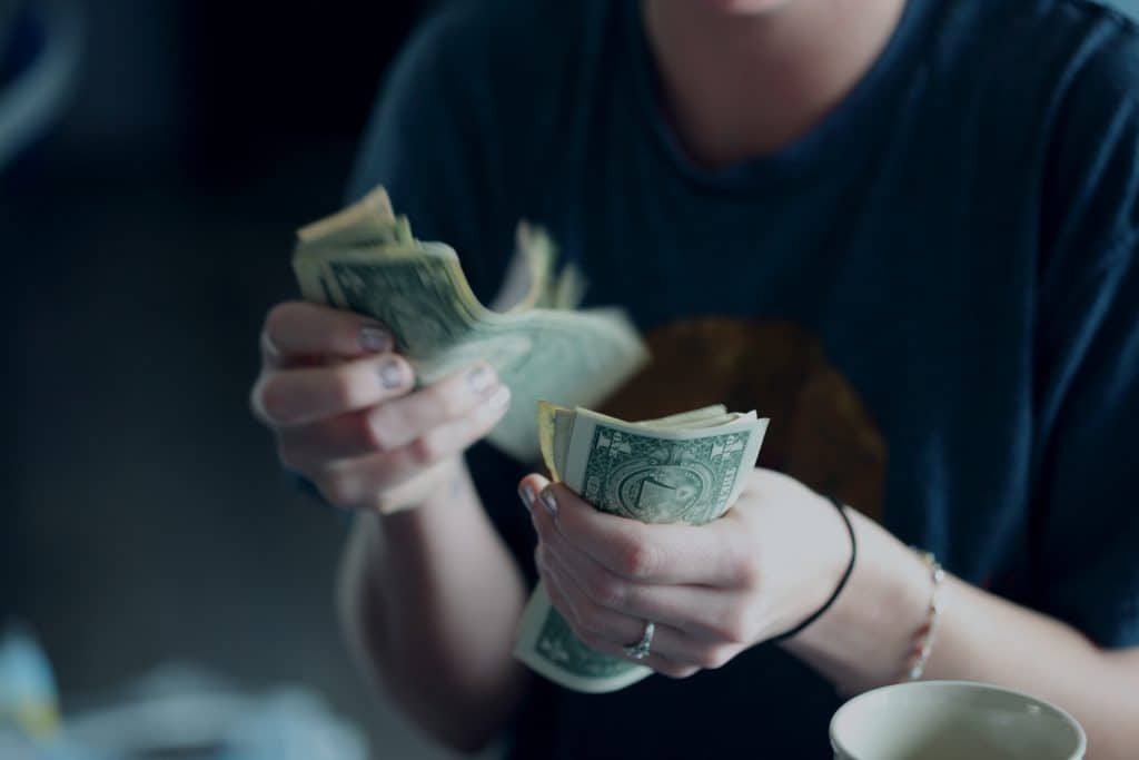 woman counting dollar bills