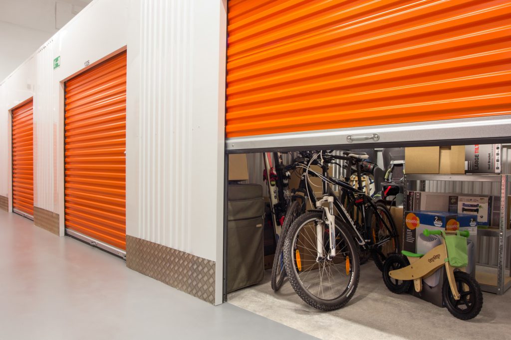 self storage unit orange doors with bicycles inside