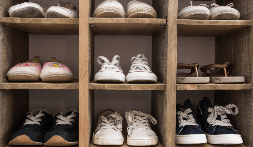 tennis shoes sneakers and flip flops in wooden shoe cubbies shoe storage