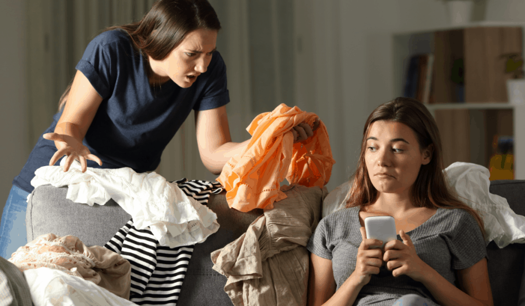 two girls roommates arguing over clothes laundry