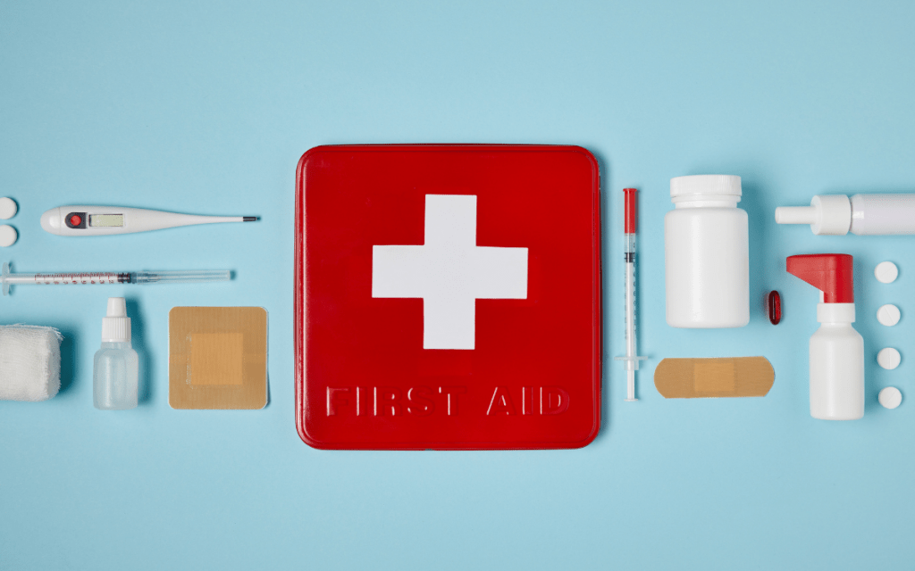 first aid kit flatlay on blue background