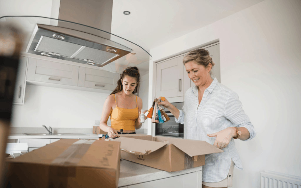 mother daughter unpacking supplies in new kitchen