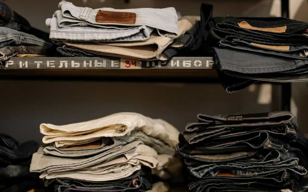 jeans clothing stacked on shelves reseller clothing inventory storage system
