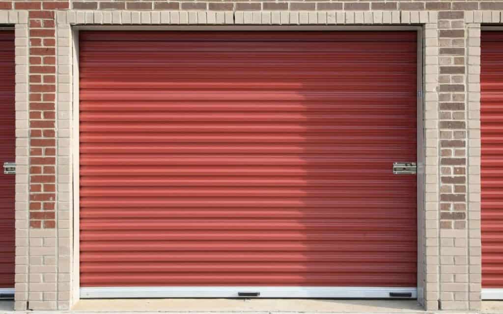 storage unit for reseller clothing inventory storage with red roll up door