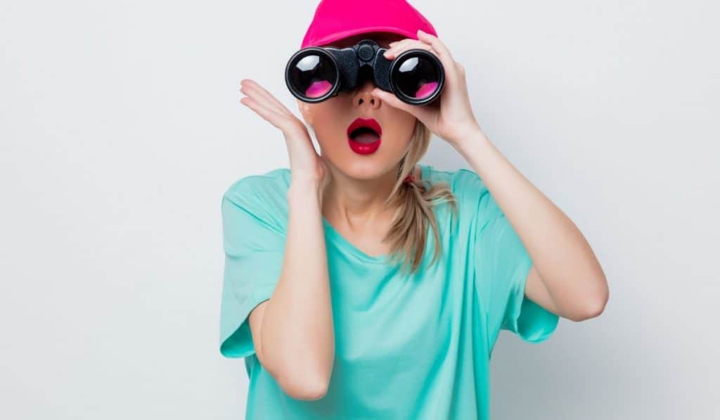 girl looking through binoculars in search for the cheapest self storage in San Francisco Bay Area