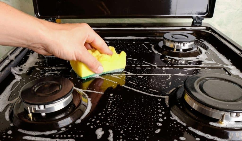 stove being cleaned