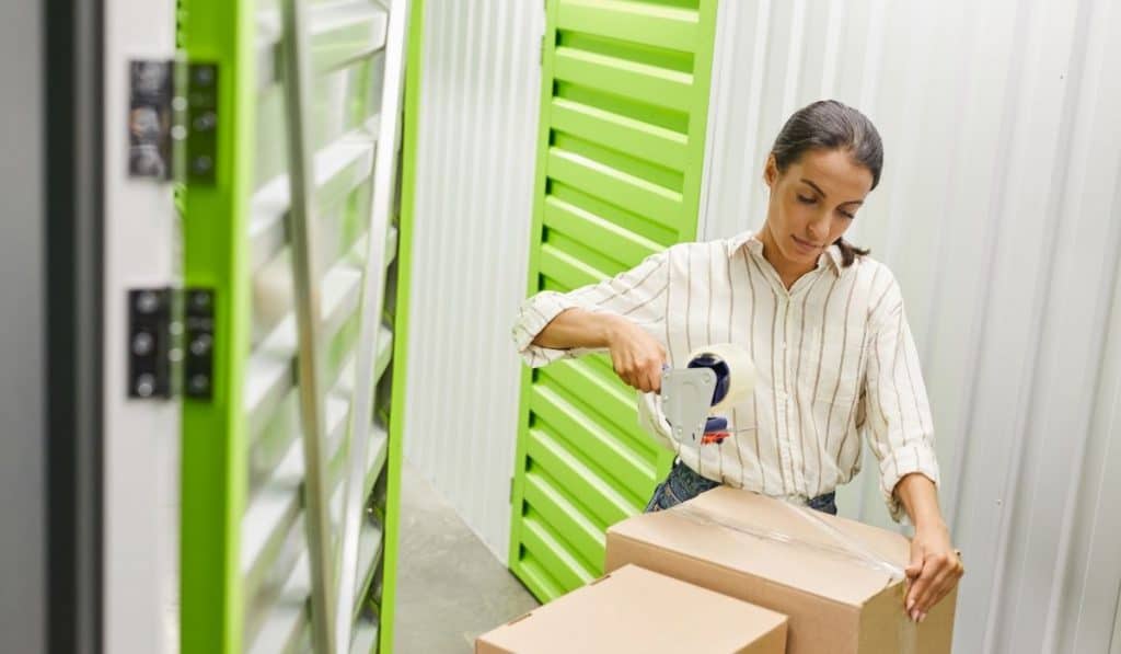 woman checking boxes to store at a storage facility unit